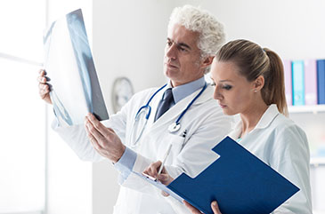 Man and woman looking at x-rays