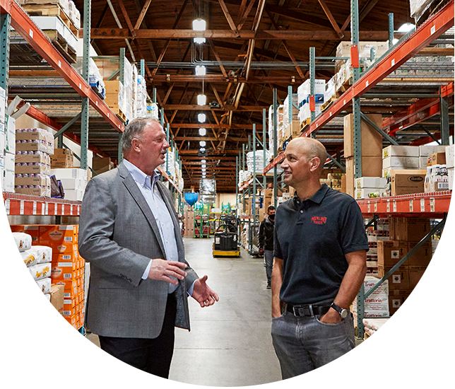 men talking in warehouse