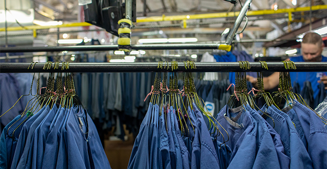 Clothes on hangers at industrial linen facility