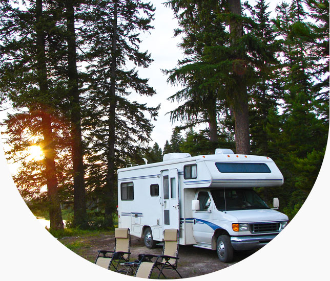 RV in the forest with chairs