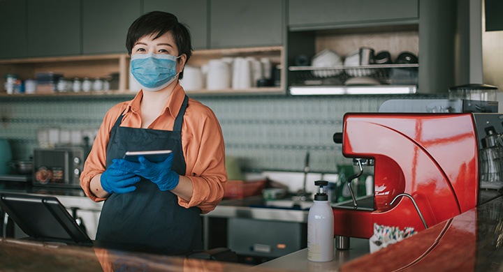 Coffee shop owner wearing a mask