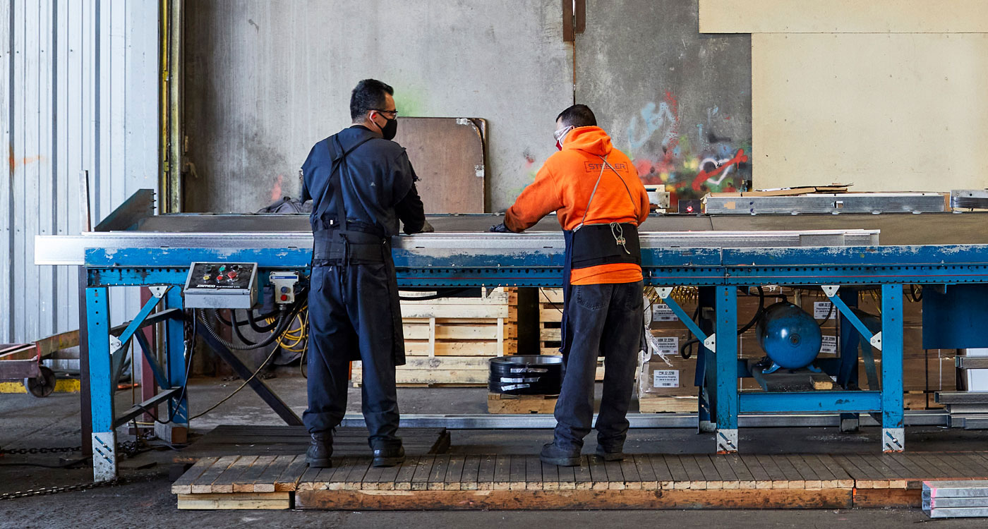 Two factory workers collaborating