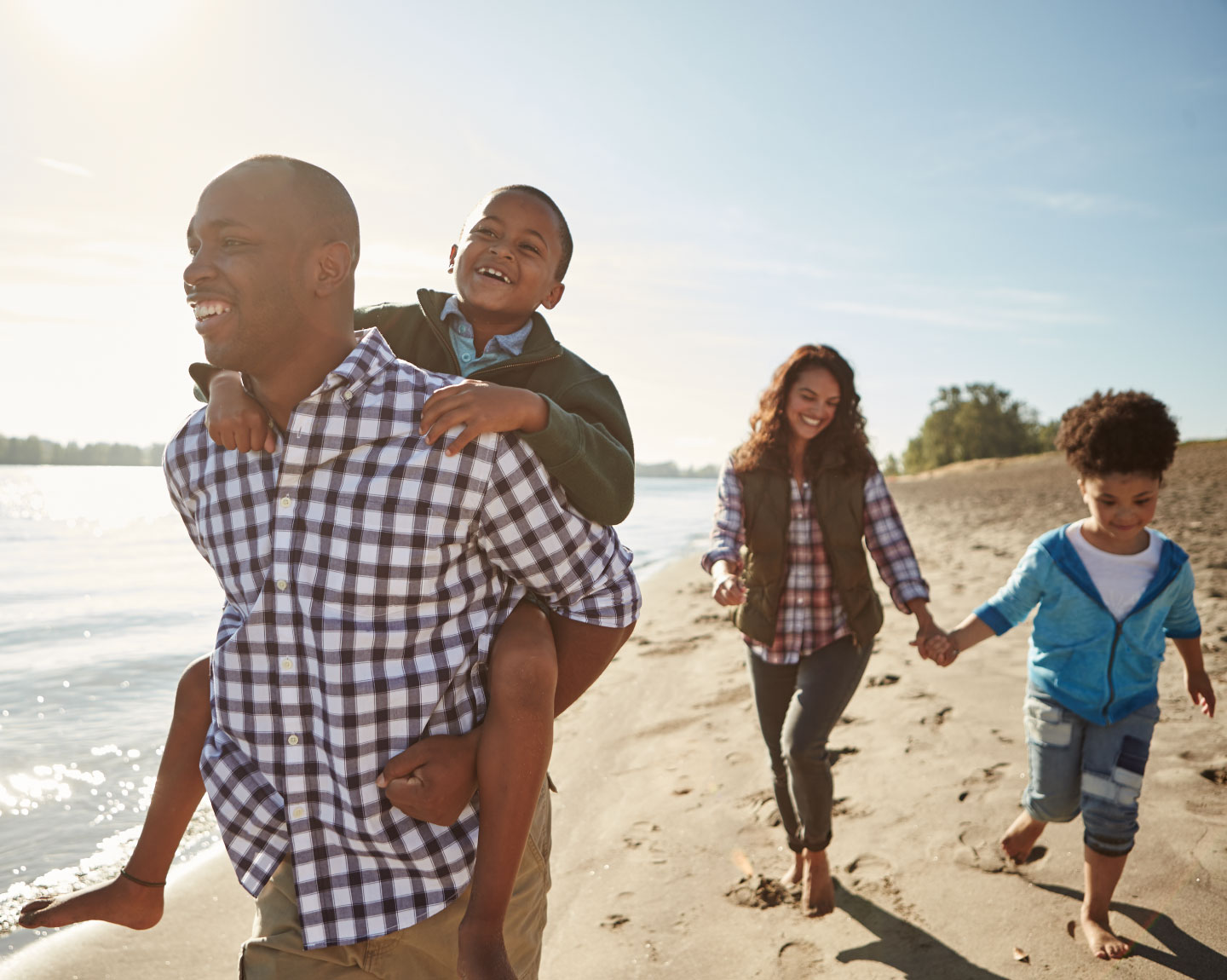 Family walks on beach smiling